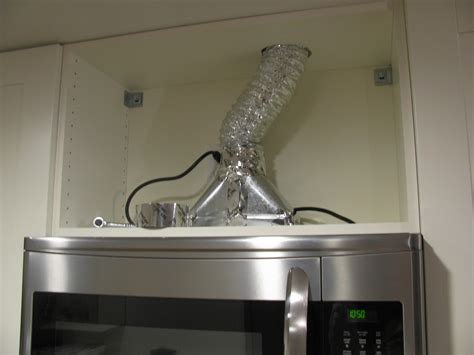 Lift the <b>microwave</b> carefully so that it attaches to the bracket. . How to vent microwave outside
